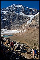 Hikers on trail below the face of Mt Edith Cavell. Jasper National Park, Canadian Rockies, Alberta, Canada (color)