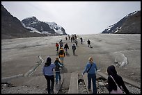 Tourists walking onto  Athabasca Glacier. Jasper National Park, Canadian Rockies, Alberta, Canada ( color)
