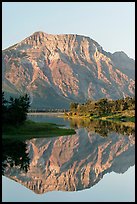 Mountain and reflection in Middle Waterton Lake, sunrise. Waterton Lakes National Park, Alberta, Canada (color)