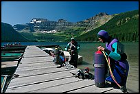 Scuba divers getting ready to dive, Cameron Lake. Waterton Lakes National Park, Alberta, Canada (color)