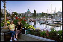 Young Women sitting, Inner harbor. Victoria, British Columbia, Canada (color)