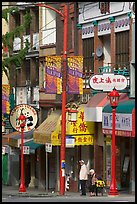 Street in Chinatown with red lamp posts and Chinese script. Vancouver, British Columbia, Canada (color)