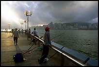 Fishing on the waterfront promenade, sunrise. Hong-Kong, China (color)