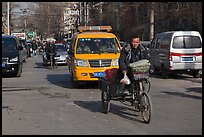 Tricycle and taxi on street. Beijing, China (color)