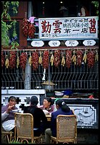 Women eat outside the Snack Food in Lijiang restaurant. Lijiang, Yunnan, China (color)