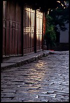 Cobblestone street and wooden doors at sunrise. Lijiang, Yunnan, China