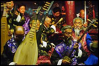 Elderly musicians of the Naxi Orchestra playing traditional instruments. Lijiang, Yunnan, China (color)