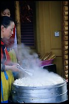 Naxi Women baking dumplings. Lijiang, Yunnan, China (color)