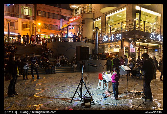 Tourists watch girl singing at night near the pier, Shueishe Village. Sun Moon Lake, Taiwan