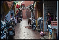 Woman cleaning in alley. Lukang, Taiwan (color)