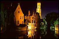 Old houses and beffroi reflected in canal at night. Bruges, Belgium (color)