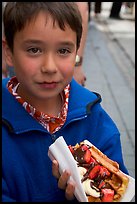 Boy eating a Belgian waffle. Brussels, Belgium (color)
