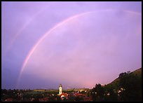 Rainbow over Nesselwang and St Andreas church. Bavaria, Germany