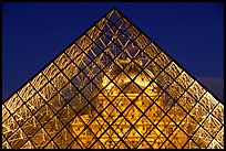 Louvre seen through pyramid at night. Paris, France