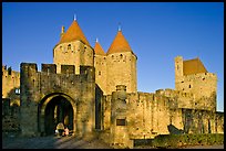Main entrance of medieval city  with child and adult walking in. Carcassonne, France