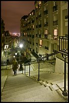 Woman on stairs by night, Montmartre. Paris, France