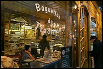 Elderly man entering bakery with people inside. Paris, France (color)