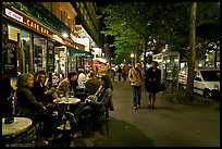 Cafe bar on sidewalk of a Grand Boulevard at night. Paris, France (color)