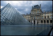 Pyramid and Richelieu wing of the Louvre under dark clouds. Paris, France