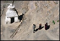 People ascending a trail past a chorten below Phuktal,  Zanskar, Jammu and Kashmir. India (color)