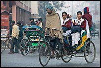 Cycle-rickshaw carrying uniformed schoolgirls. New Delhi, India (color)