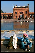 Women sitting near basin in courtyard of Jama Masjid. New Delhi, India (color)