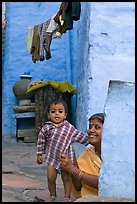 Baby girl and woman in blue alley. Jodhpur, Rajasthan, India