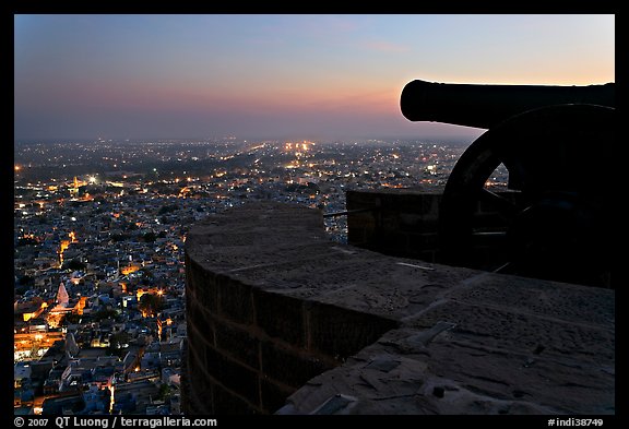 Cannon on top of Mehrangarh Fort, and city lights below. Jodhpur, Rajasthan, India