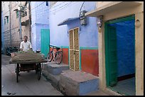 Man with vegetables car in front of painted house. Jodhpur, Rajasthan, India