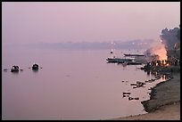 Ganges River at sunset with cremation fire. Varanasi, Uttar Pradesh, India (color)