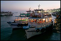 Lighted tour boat at quay,  sunset. Mumbai, Maharashtra, India (color)