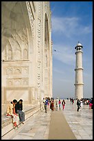 Couple sitting on side pishtaq and tourists strolling on platform, Taj Mahal. Agra, Uttar Pradesh, India ( color)