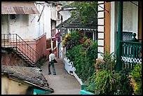 Man in alley with gardens, Panjim. Goa, India (color)