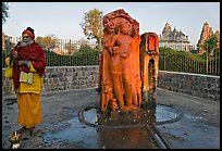 Holy man next to Shiva image. Khajuraho, Madhya Pradesh, India ( color)