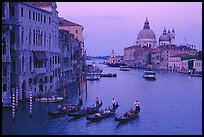 Gondolas, Grand Canal, Santa Maria della Salute church from the Academy Bridge,  sunset. Venice, Veneto, Italy (color)