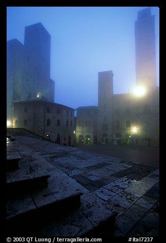 Piazza del Duomo at dawn in the fog. San Gimignano, Tuscany, Italy