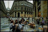 Women enjoy gelato inside the Galleria Umberto I. Naples, Campania, Italy (color)