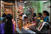 Devotees inside Tamil Nadu temple. George Town, Penang, Malaysia (color)