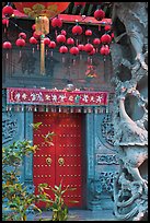 Red paper lanters, door, and stone carved wall, Hainan Temple. George Town, Penang, Malaysia (color)