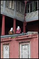 Women sitting, Stadthuys. Malacca City, Malaysia ( color)
