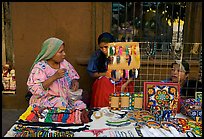 Huichol women selling crafts on the street, Tlaquepaque. Jalisco, Mexico (color)