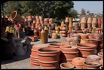 Pots for sale, with a man loading in the background, Tonala. Jalisco, Mexico (color)