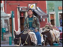 Young man riding a donkey in the streets. Guanajuato, Mexico (color)
