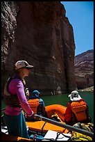 On raft below redwall limestone cliff dropping straight into Colorado River. Grand Canyon National Park, Arizona