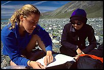 Women hikers consulting a map. Lake Clark National Park, Alaska (color)