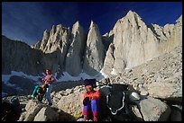 Man and woman pausing with backpacks below the East face of Mt Whitney. Sequoia National Park, California (color)