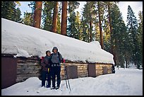 Skiing couple in front of the Mariposa Grove Museum in winter. Yosemite National Park, California ( color)