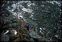 Backpacker in boulder field at the base of the Arrigetch Peaks. Gates of the Arctic National Park, Alaska ( color)