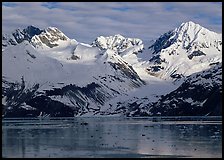 Coastal mountains with glacier dropping into icy fjord. Glacier Bay National Park, Alaska, USA. (color)