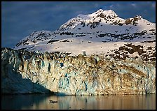 Face of Lamplugh Glacier illuminated by the sun on cloudy day. Glacier Bay National Park ( color)